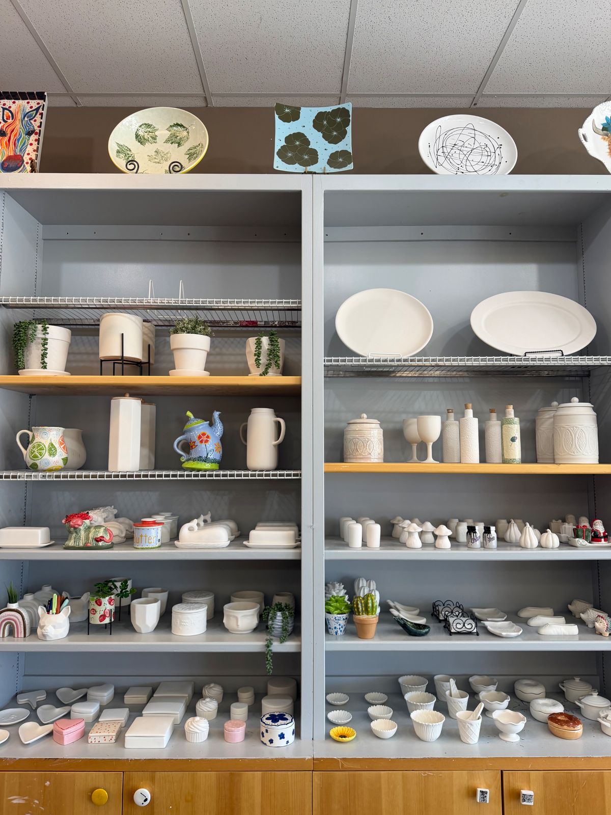 Shelves of ready-to-paint pottery bisque in the Creativity Center