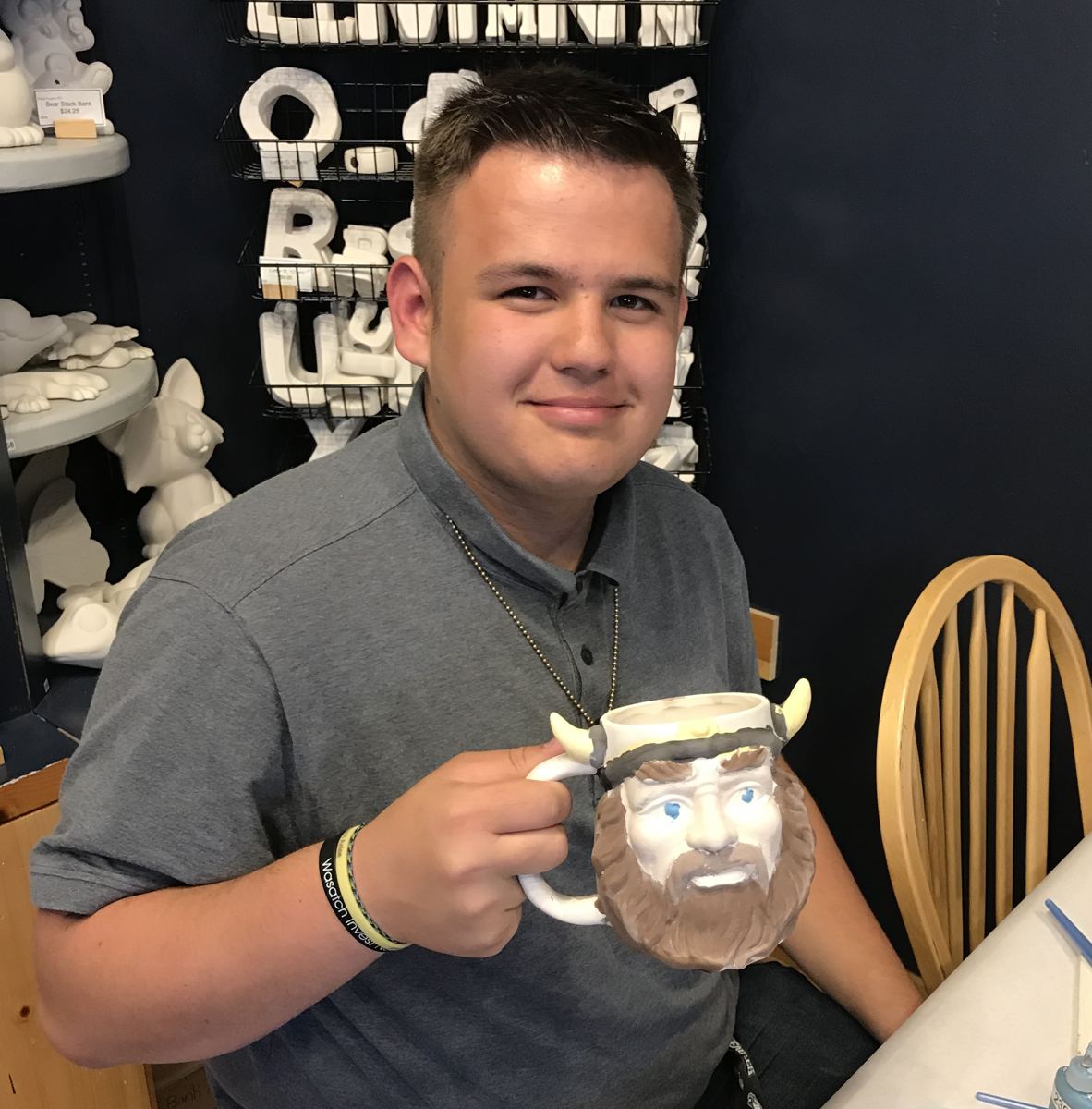A guest painting a character mug during an in-store event