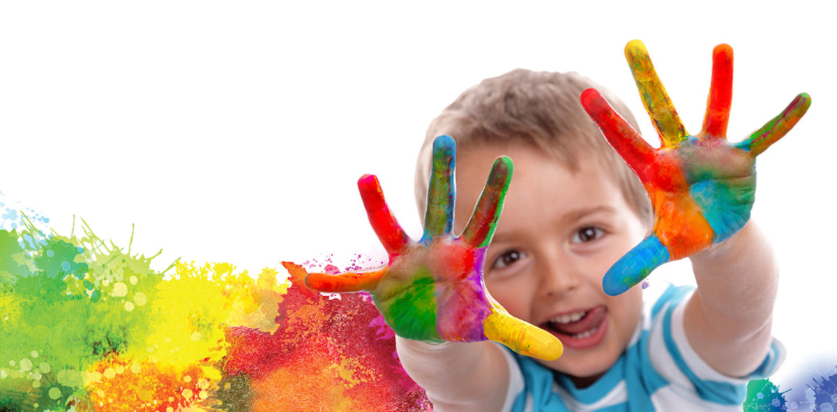 A smiling child holding up hands covered in colorful paint at a pottery painting party